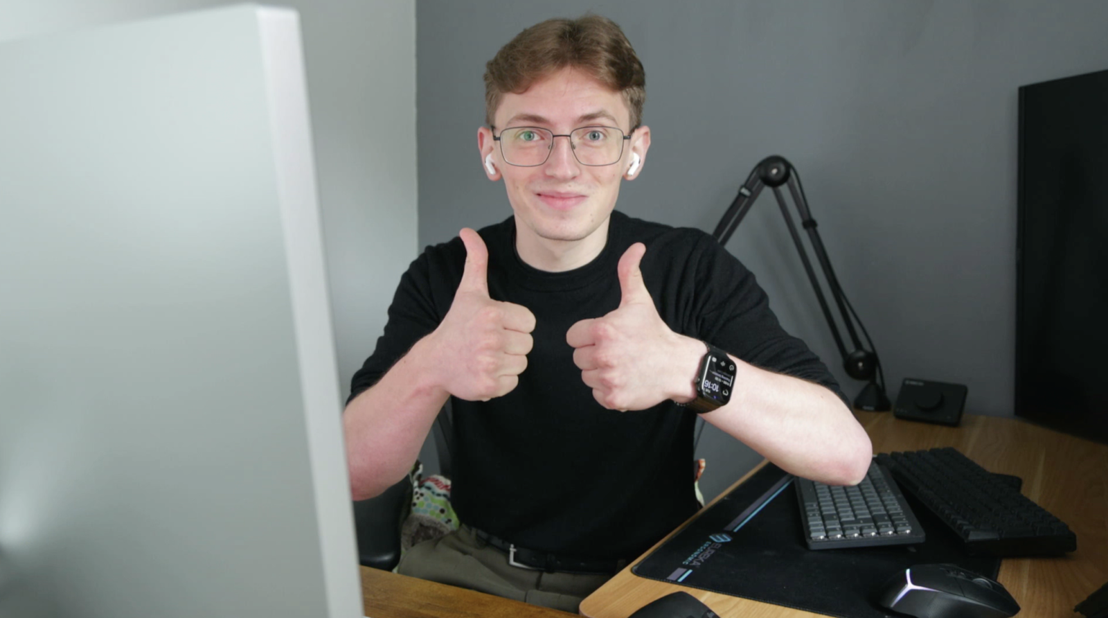 CMYSZ - Charlie Myszkowski - Thumbs Up Young man with glasses giving double thumbs up at desk.